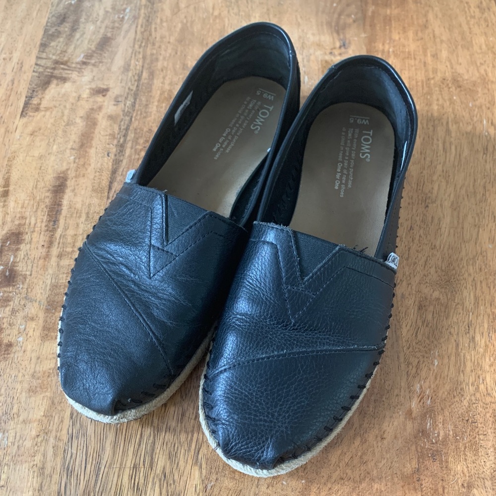 Black leather slip on Toms - size 9.5
